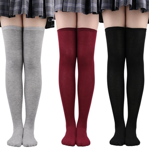 Three pairs of striped over-the-knee socks in grey, wine red, and black knit fabric