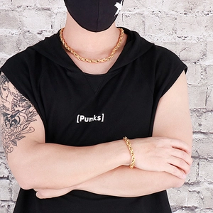 Detailed view of hip hop snake link chain necklace and bracelet on model wearing black hoodie