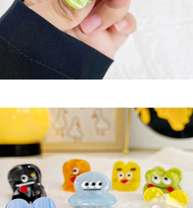 Detailed macro view of colorful cartoon acetic acid hair claws with cute expressions