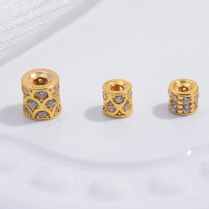 Macro shot of three S925 sterling silver gold barrel beads with micro-paved cubic zirconia