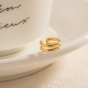 Elegant 18k gold plated double layer ear cuff for women on minimalist white ceramic