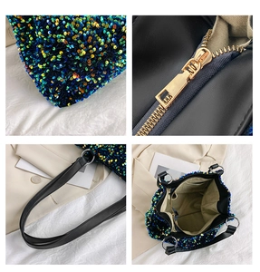 Detail view of colorful sequin fabric, gold zipper, black strap, and beige interior lining