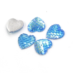 Macro view of 14mm heart resin gems with blue fish scale texture and silver backing
