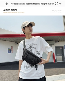 Outdoor shot of black utility crossbody bag with multi-pockets and adjustable buckle strap