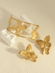 Detailed close-up of 18k gold plated stainless steel butterfly bracelet and earrings set