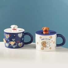Detail of blue and beige ceramic mugs with cute dog lids and Lucky Dog patterns