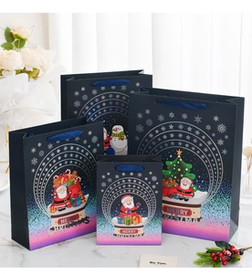 Detailed set of Christmas gift bags in dark blue and pink gradient with satin handles