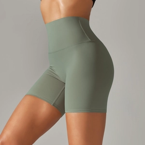 Detail of high-waist sage green yoga shorts with seamless fabric and tummy control