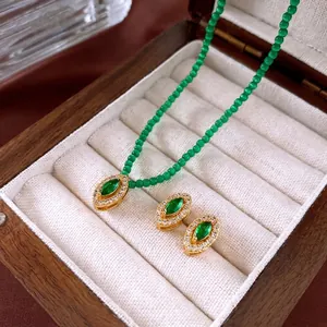 Vintage gold and green marquise jewelry set with beaded necklace and oval stud earrings