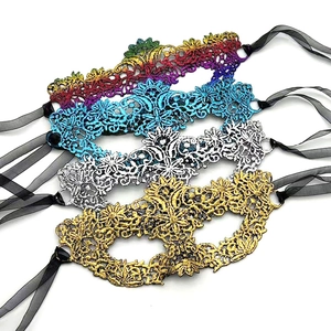 Detailed macro of embroidered lace masquerade masks with intricate textures and silk ribbons