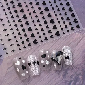 Self-adhesive nail art stickers featuring black hearts and stars on silver glitter nails