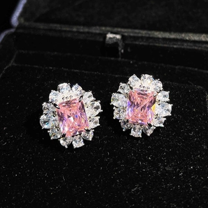 Detailed view of pink rectangular-cut diamond earrings in a black velvet gift box