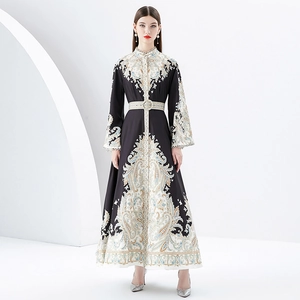 Elegant paisley print maxi dress with bell sleeves and decorative belted waist detail