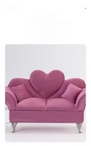 Detail of purple velvet heart-shaped sofa jewelry box with ornate silver carved legs