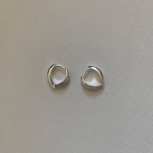 Detailed view of silver hoop earrings with micro-pave white cubic zirconia stones