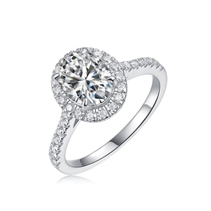 Detailed view of an oval-cut moissanite ring with halo setting and pavé band in silver