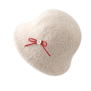 Creamy white lamb wool bucket hat for women with a sweet red bow accent for winter