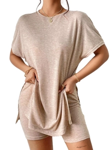 Detail of oat beige knitted summer set showing textured batwing top and biker shorts
