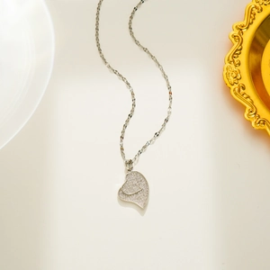 Silver double heart pendant necklace with shimmering crystals on a 18K gold plated chain