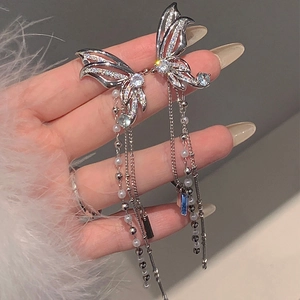 Detailed close-up of sparkling zircon butterfly earrings with long fringe tassels