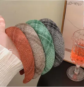 Detail of four thick wool sponge headbands in red, brown, green and grey colors