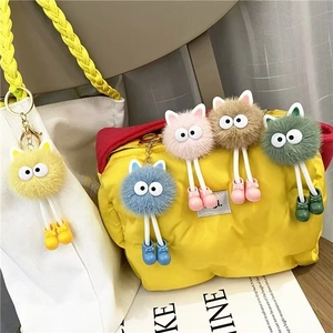 Colorful plush keychain set with large eyes on stylish bags, soft faux fur bag charms