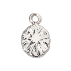 Macro shot of silver stainless steel pendant with textured snowflake pattern and hanging ring