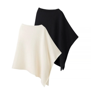 Minimalist asymmetrical knit poncho set in black and cream white with soft wool texture