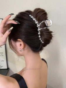 Silver bead cluster hair claw clip shown in a sophisticated updo on a model's head