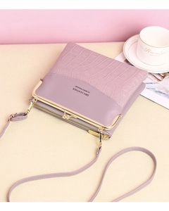 Detailed view of pink croc-embossed PU leather bag with gold clasp and chain strap