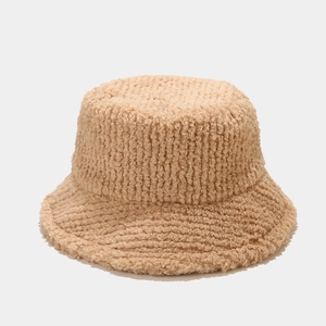 Close-up of thick plush lamb wool bucket hat featuring warm textured stripes in beige