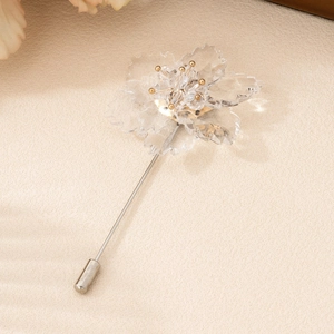 Elegant floral crystal brooch with gold stamen and pin shown in a premium aesthetic setting