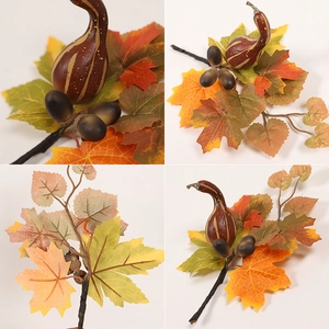 Artificial autumn maple leaf branch with pumpkin and acorns for festive decoration