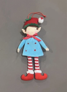 Detailed flat lay of colorful Christmas elf plush ornaments in red, blue, and green colors