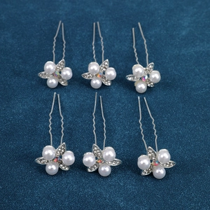 Detail of silver flower hair pins with pearls and rhinestones for bridal styling