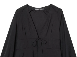 Detail of black V-neck top showing tie-front waist and brand label in S size