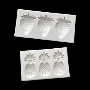 Detail of 3-cavity strawberry and pineapple silicone molds for fondant cake decorating