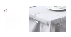 Close-up of transparent tablecloth clips fixing white fabric securely on a table edge