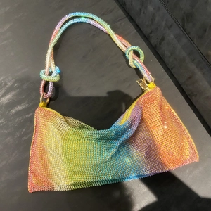 Detail shot of rainbow rhinestone mesh underarm bag with knotted strap and crystal texture