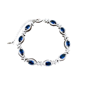 Vintage palace style bracelet with oval blue zircon and silver-tone diamond accents