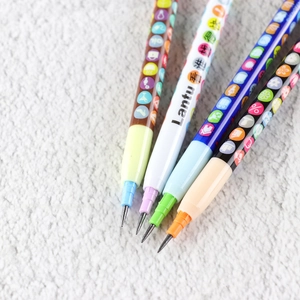 Close-up of four colorful stackable pencils with rubber grips on white fuzzy background