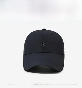 Detailed view of the 3D embroidered white S letter on a navy blue baseball cap
