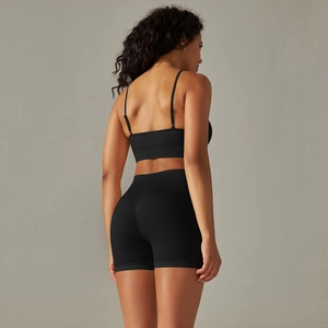 Rear view of black seamless knitted yoga bra and high waist lifting sports shorts