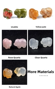 Detailed view of hand-carved natural pig figurines in unakite, quartz, and jade stones