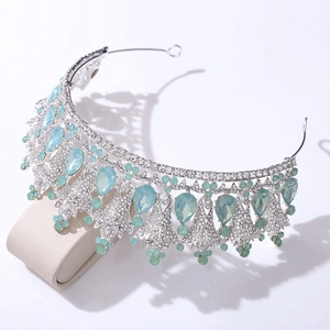 Detailed close-up of Baroque silver bridal crown with light blue gemstones and crystals