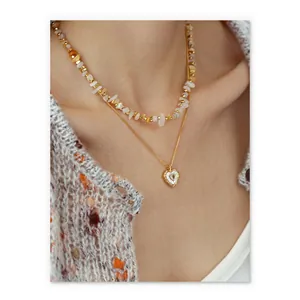 Layered gold necklace with natural stones and an irregular heart pendant for women