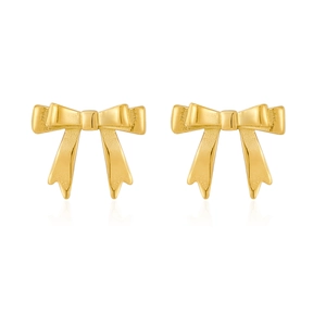 Detail of golden bow stud earrings featuring textured ribbon design and polished finish