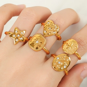 Polished gold plated titanium steel geometric rings set with sparkling zircons