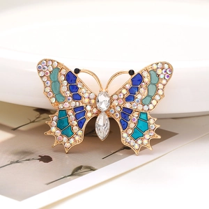 Macro shot of zinc alloy butterfly pendant with colorful rhinestones and blue enamel inlay