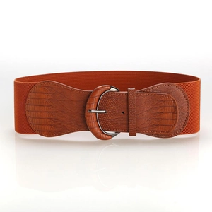 Detail of wide elastic waist belt featuring a brown crocodile texture leather buckle